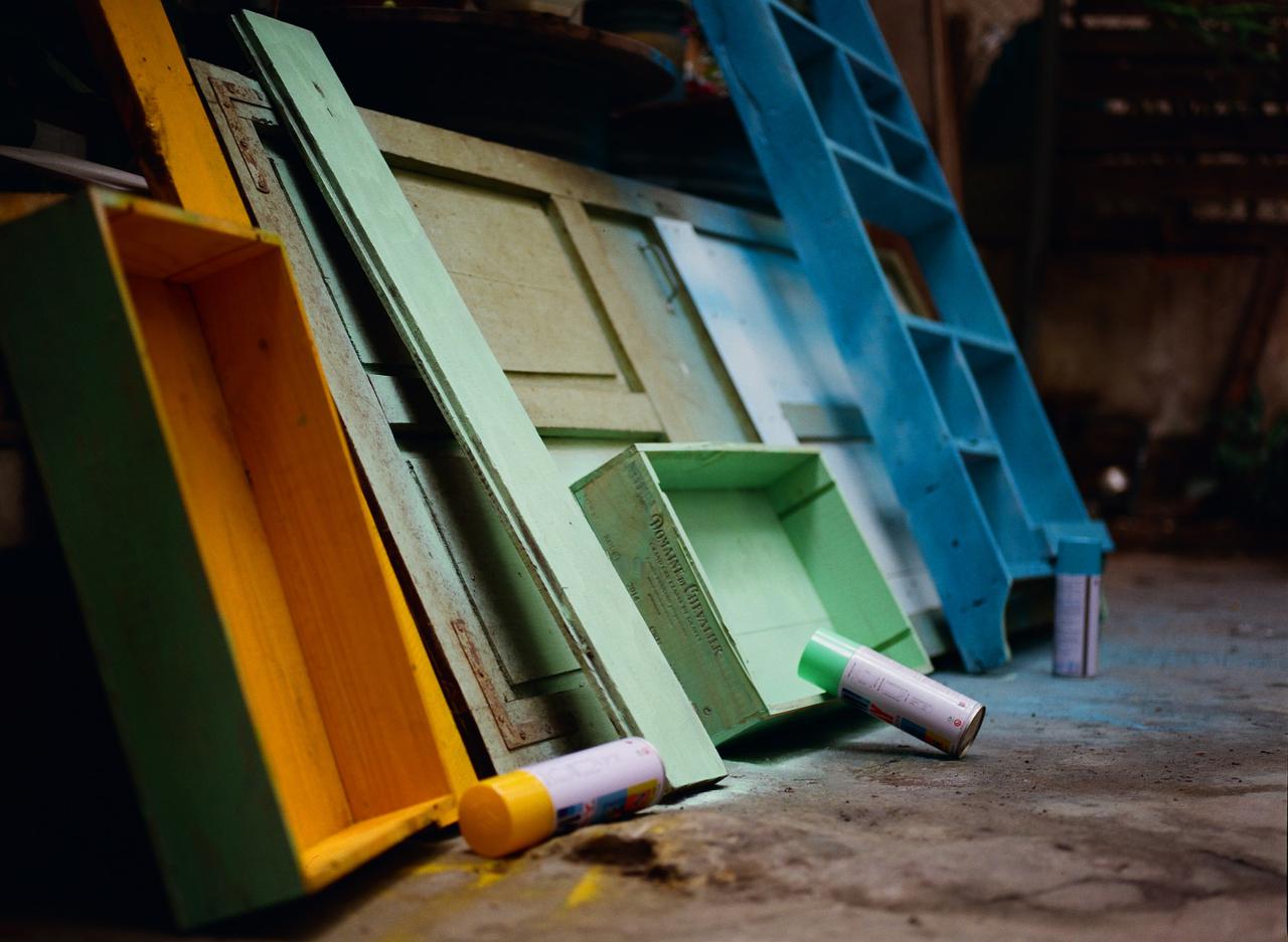 Some drawers and a bookshelf are being painted for reuse