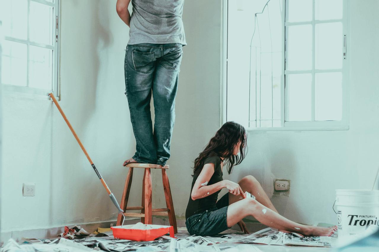 Pareja pintando su nuevo hogar.